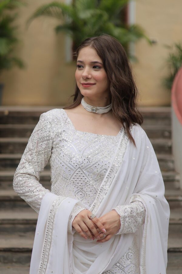 Premium Designer Sharara Suit in White and Maroon, featuring sequins and thread embroidery on faux georgette, paired with a flowing sharara and embroidered dupatta.