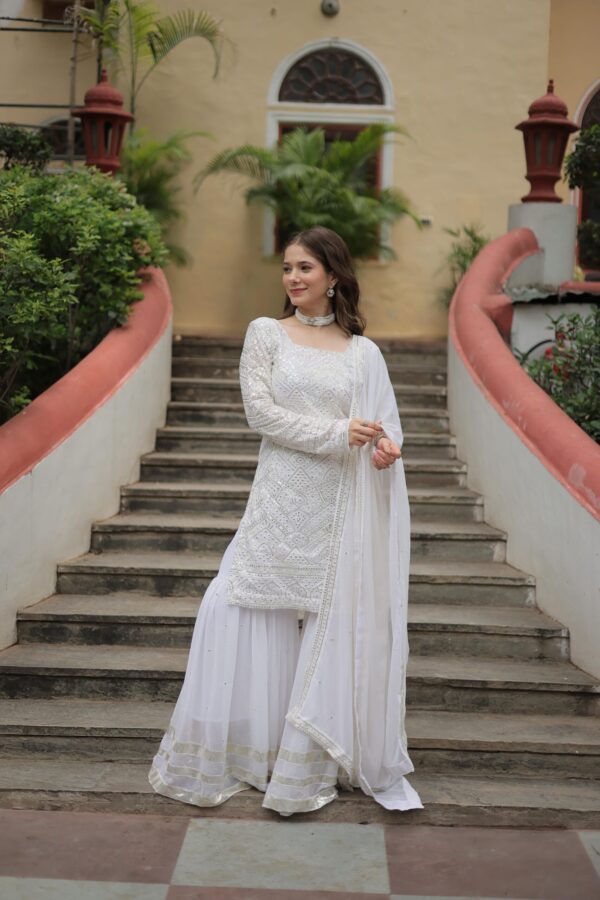 Premium Designer Sharara Suit in White and Maroon, featuring sequins and thread embroidery on faux georgette, paired with a flowing sharara and embroidered dupatta.