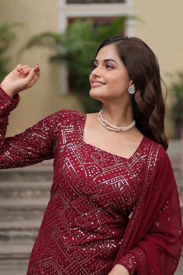 Premium Designer Sharara Suit in White and Maroon, featuring sequins and thread embroidery on faux georgette, paired with a flowing sharara and embroidered dupatta.